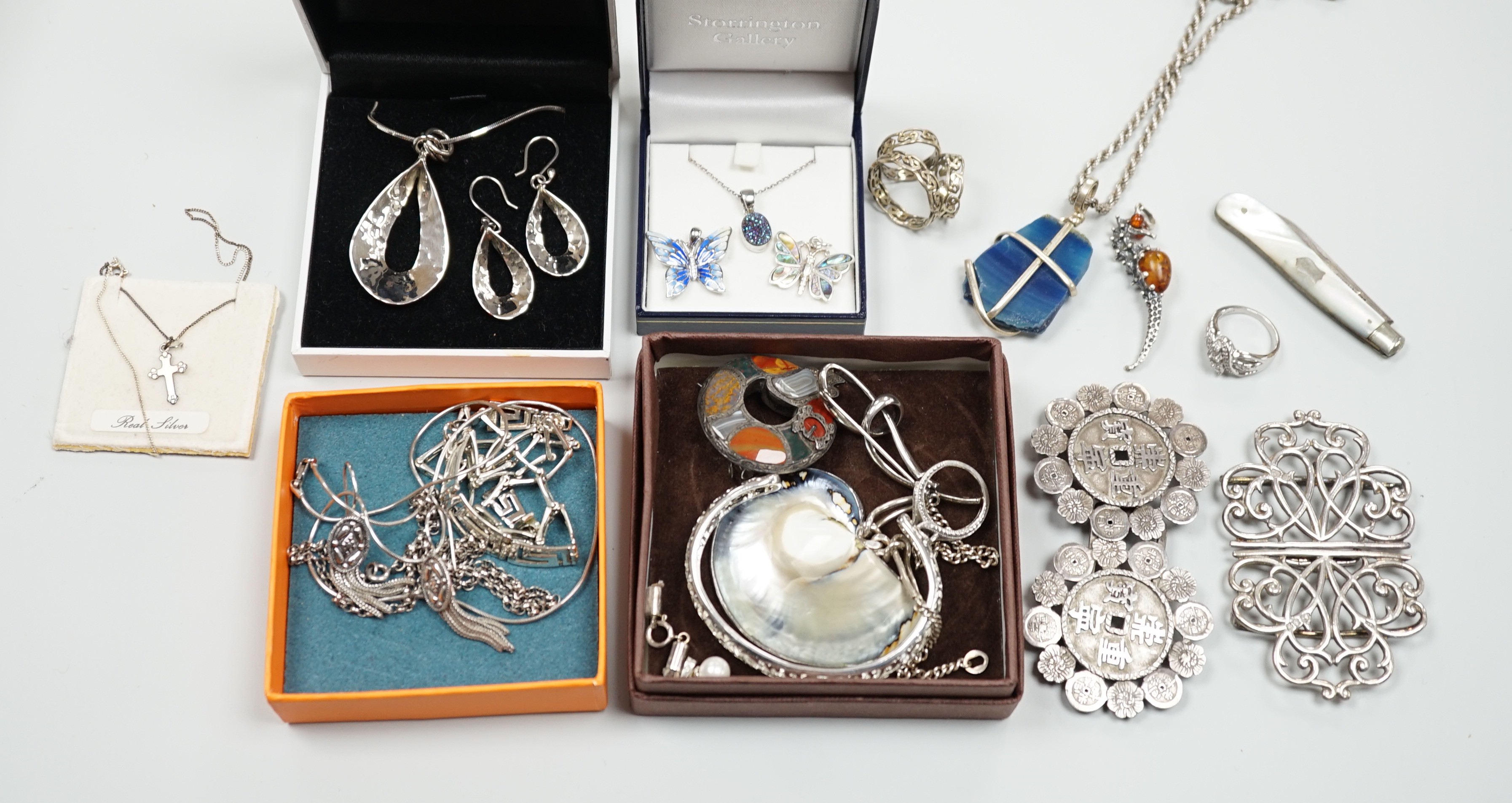 Mixed silver and white metal jewellery including a modern silver nurses buckle, an early 20th century white metal and Scottish hardstone brooch, Chinese white metal buckle by Wang Hing, etc.